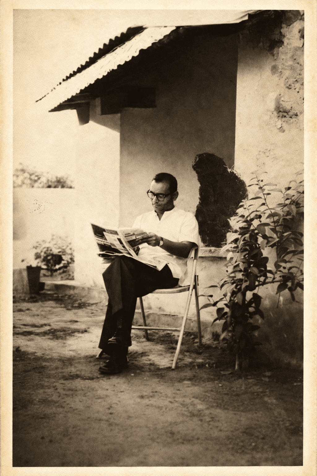 Professor Madiraju Ranga Rao reading a newspaper outdoors during his early years